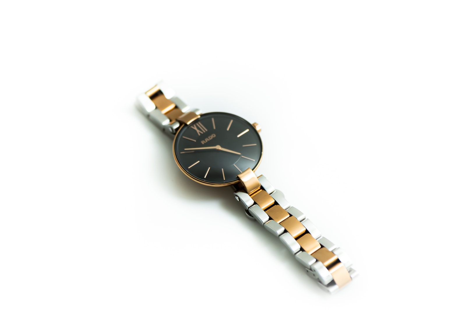 gold and silver round analog watch