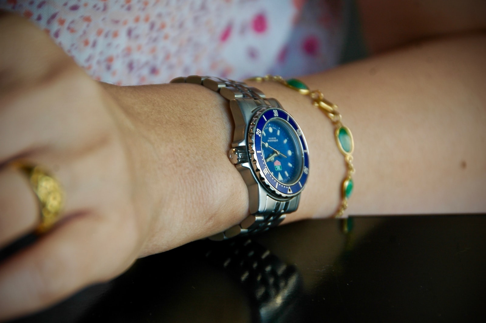 person wearing round blue analog watch